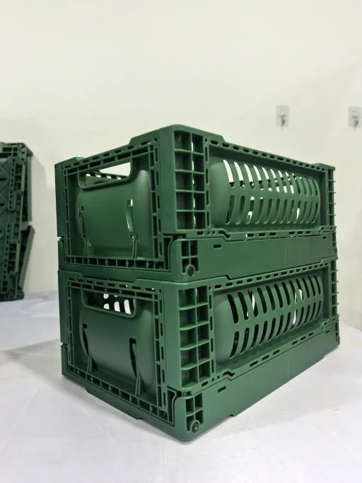 Two green collapsible plastic crates stacked in the open position