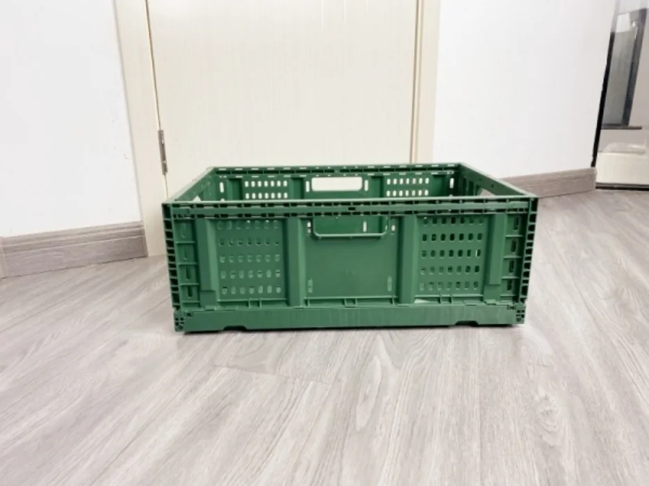 Side view of the green TY6040195W-S ventilated folding crate